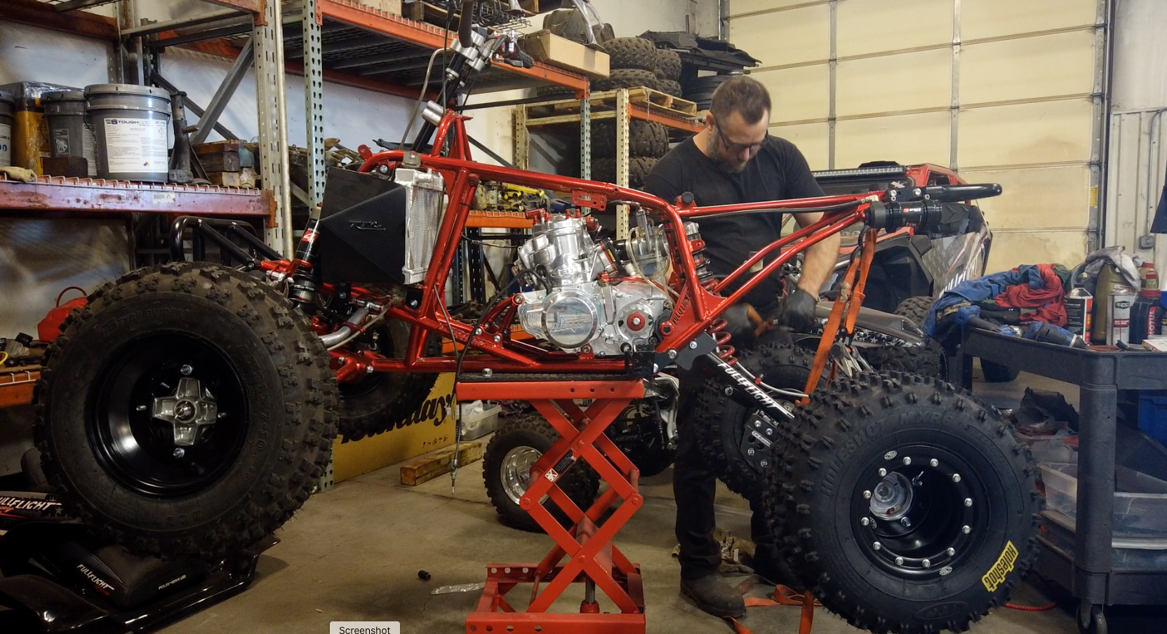 photo of an auto-mechanic working on an ATV