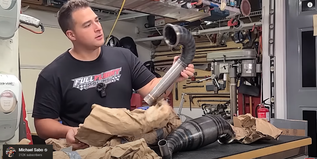 photo of an auto mechanic looking at a part